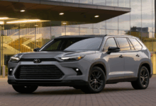 2026 Toyota Grand Highlander in Celestial Silver Metallic with sleek LED headights, roof rails, and spacious SUV body, showcasing modern design and hyvrid technology.